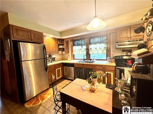 162 Sturges St, Jamestown, NY 14701 - kitchen with appliances with stainless steel finishes, a sink, under cabinet range hood, brown cabinets, and light countertops