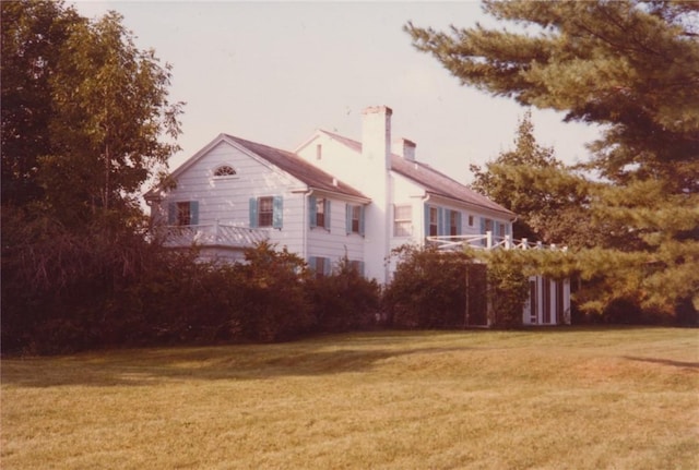 1516 Lake Rd, Webster, NY 14580 - view of side of home featuring a yard and a chimney