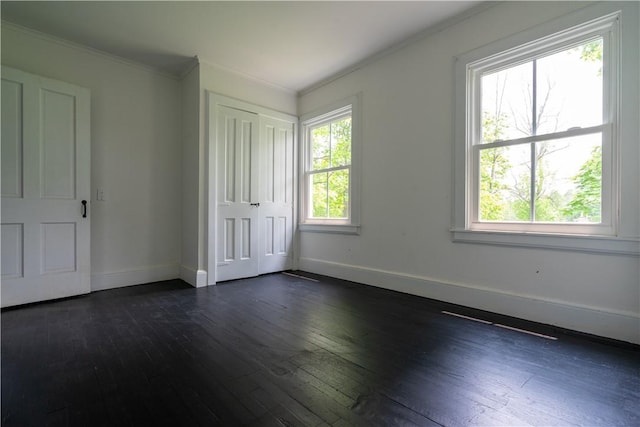 1516 Lake Rd, Webster, NY 14580 - unfurnished bedroom with dark wood finished floors, baseboards, crown molding, and a closet