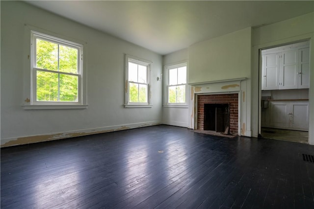 1516 Lake Rd, Webster, NY 14580 - unfurnished living room featuring dark wood-style floors, a brick fireplace, and baseboards