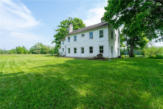 1516 Lake Rd, Webster, NY 14580 - back of property with a chimney and a lawn