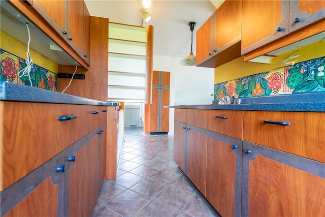 1516 Lake Rd, Webster, NY 14580 - kitchen with brown cabinetry, light tile patterned floors, pendant lighting, and dark countertops