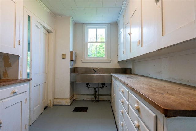 1516 Lake Rd, Webster, NY 14580 - kitchen with white cabinetry, butcher block countertops, and a sink