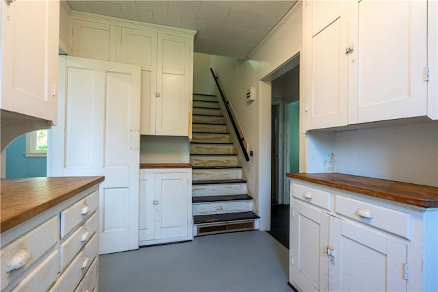 1516 Lake Rd, Webster, NY 14580 - kitchen with wood counters, white cabinets, finished concrete flooring, and arched walkways