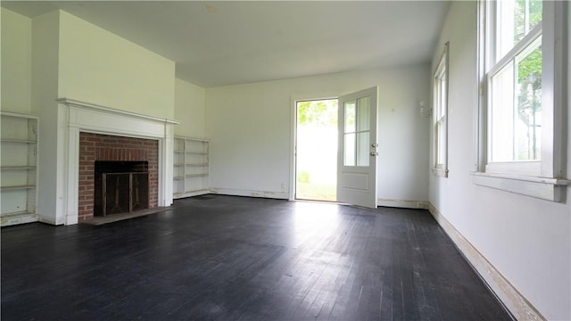 1516 Lake Rd, Webster, NY 14580 - unfurnished living room featuring dark wood-type flooring, a brick fireplace, and baseboards