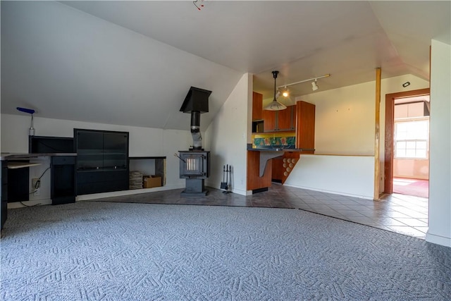 1516 Lake Rd, Webster, NY 14580 - unfurnished living room with a wood stove, vaulted ceiling, tile patterned floors, and rail lighting