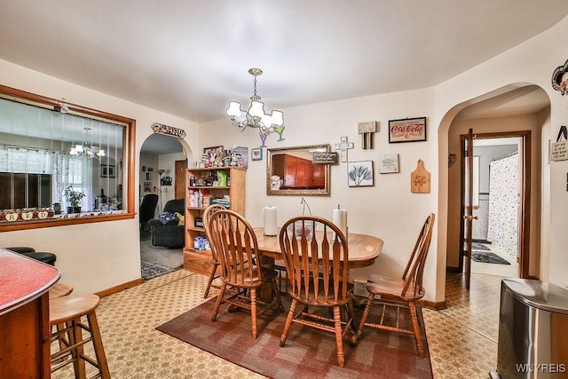 102 Wellworth Pl, Cheektowaga, NY 14225 - dining space featuring a chandelier, arched walkways, and tile patterned floors