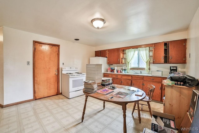 102 Wellworth Pl, Cheektowaga, NY 14225 - kitchen featuring white electric range, light countertops, brown cabinets, light floors, and baseboards