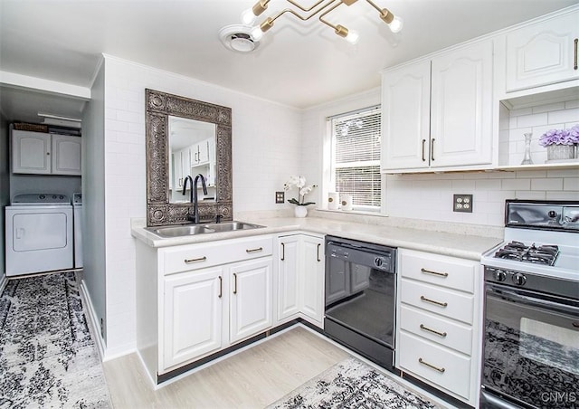 1615 Cortland St, Deruyter, NY 13052 - kitchen featuring range with gas stovetop, black dishwasher, a sink, independent washer and dryer, and white cabinets