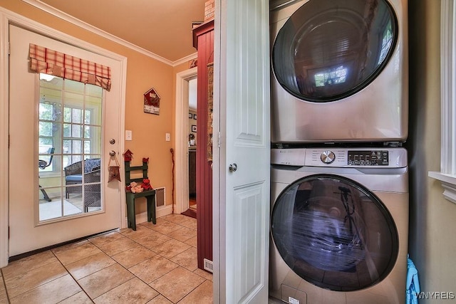 117 Stutzman Rd, Lancaster, NY 14026 - laundry room with estacked washer and dryer, crown molding, light tile patterned floors, and baseboards