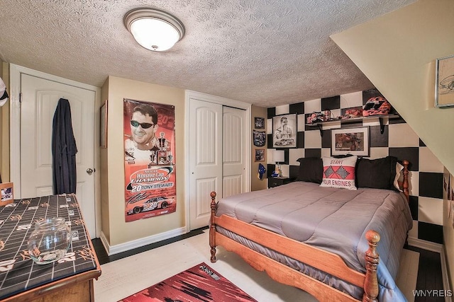 117 Stutzman Rd, Lancaster, NY 14026 - bedroom with a closet, a textured ceiling, wood finished floors, and baseboards