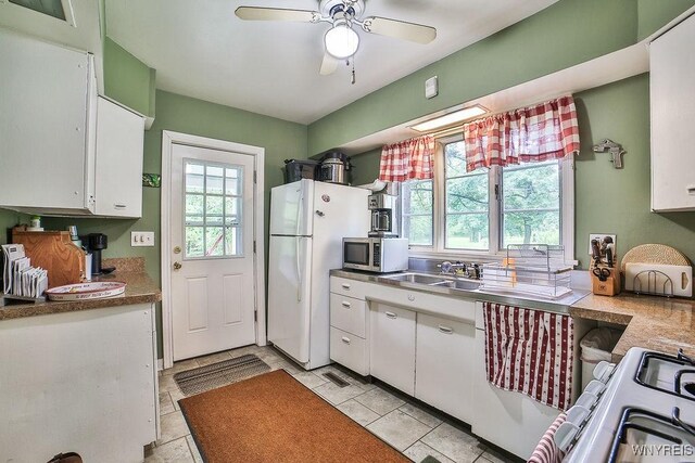 117 Stutzman Rd, Lancaster, NY 14026 - kitchen featuring freestanding refrigerator, stainless steel microwave, white cabinetry, and ceiling fan
