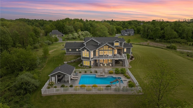1915 Factors Walk, West Bloomfield, NY 14475 - back of house featuring a balcony, stone siding, stairway, and a wooded view