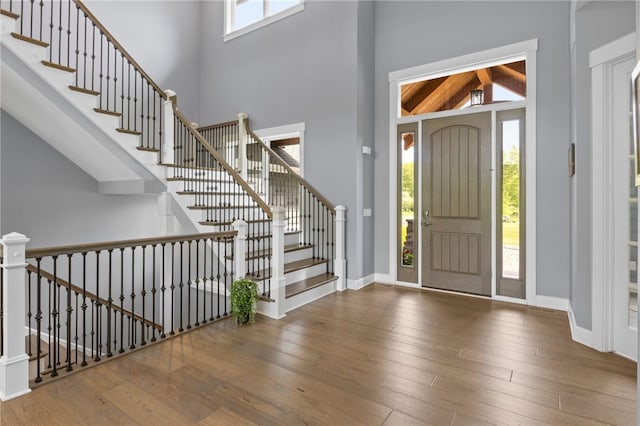 1915 Factors Walk, West Bloomfield, NY 14475 - entryway featuring wood-type flooring, baseboards, a high ceiling, and stairway
