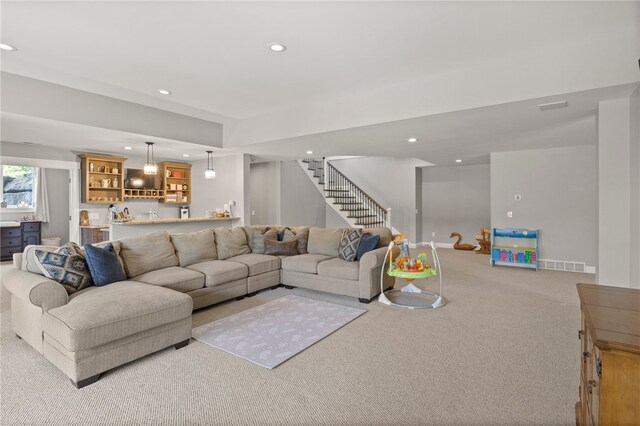 1915 Factors Walk, West Bloomfield, NY 14475 - carpeted living area featuring bar with sink, stairway, and recessed lighting
