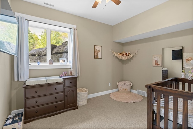 1915 Factors Walk, West Bloomfield, NY 14475 - carpeted bedroom featuring a nursery area, baseboards, and ceiling fan