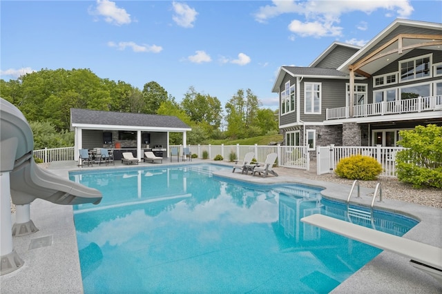 1915 Factors Walk, West Bloomfield, NY 14475 - view of swimming pool with a water slide, a patio, a diving board, and an outdoor structure
