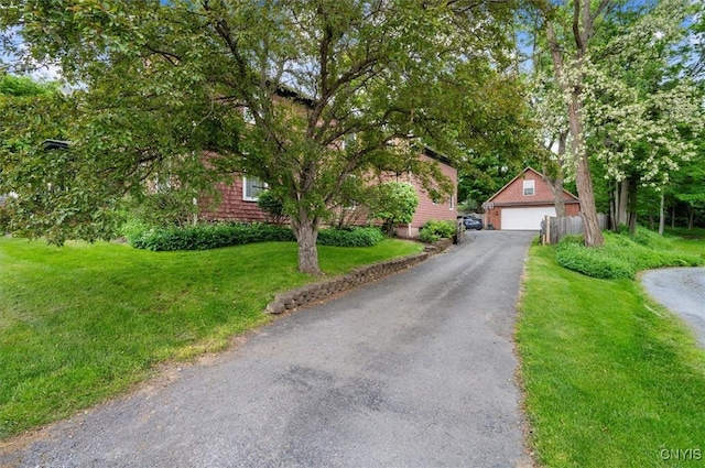 26 Utica St, Kirkland, NY 13323 - obstructed view of property with a garage, an outdoor structure, and a front lawn