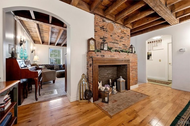 26 Utica St, Kirkland, NY 13323 - living area featuring wooden ceiling with exposed beams, light wood finished floors, baseboards, and a brick fireplace