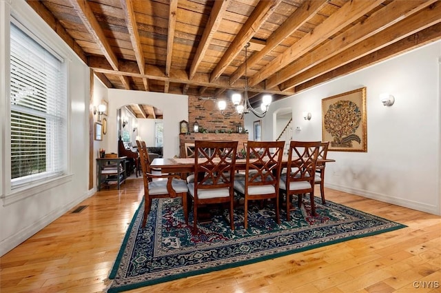 26 Utica St, Kirkland, NY 13323 - dining area featuring wooden ceiling with exposed beams, arched walkways, light wood-type flooring, baseboards, and a chandelier