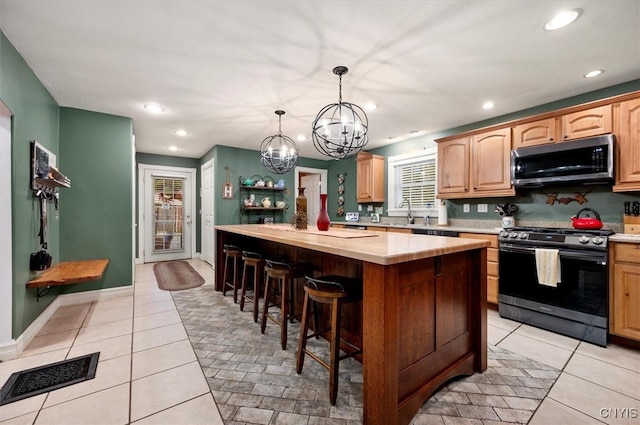 26 Utica St, Kirkland, NY 13323 - kitchen featuring gas range, light countertops, a center island, a chandelier, and a breakfast bar