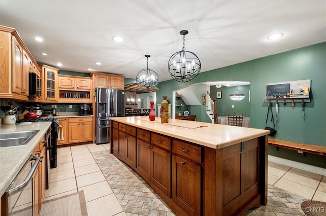26 Utica St, Kirkland, NY 13323 - kitchen with appliances with stainless steel finishes, a chandelier, recessed lighting, glass insert cabinets, and a kitchen island