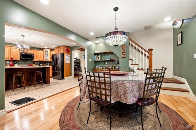 26 Utica St, Kirkland, NY 13323 - dining room with a chandelier, light wood-style flooring, stairs, and recessed lighting