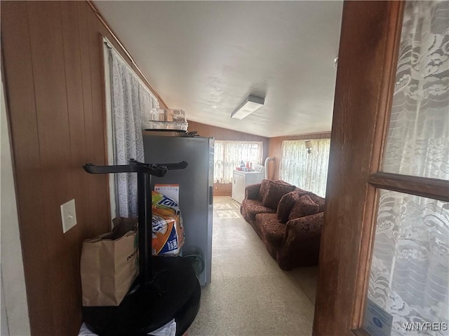340 Martha Ave, Buffalo, NY 14215 - carpeted living room with wooden walls, vaulted ceiling, and water heater