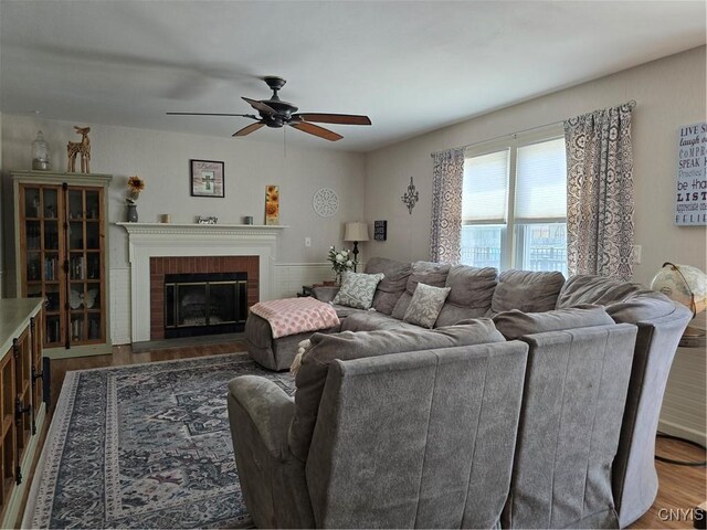 4982 Alfred Dr, Clay, NY 13090 - living area featuring a ceiling fan, wood finished floors, and a brick fireplace