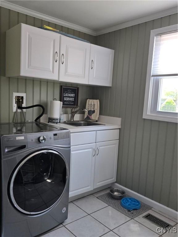 4982 Alfred Dr, Clay, NY 13090 - laundry area with washer / dryer, cabinet space, light tile patterned floors, and crown molding
