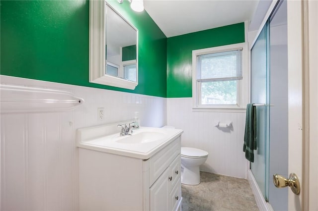 223 S Ave, Parma, NY 14468 - bathroom with vanity, toilet, a shower with door, and a wainscoted wall