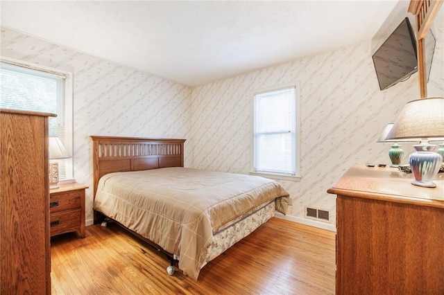 223 S Ave, Parma, NY 14468 - bedroom with light wood-style flooring, wallpapered walls, and baseboards