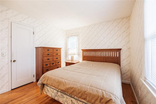 223 S Ave, Parma, NY 14468 - bedroom featuring wallpapered walls, light wood finished floors, and baseboards