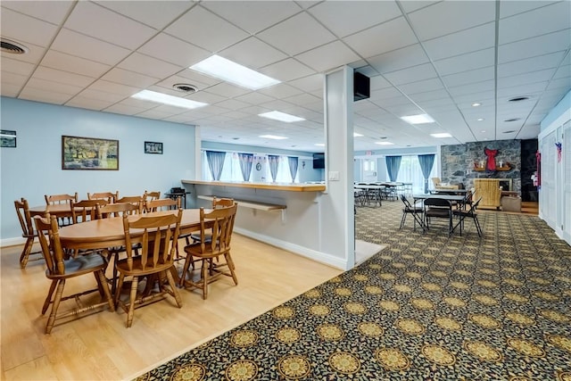 503 Valley Creek Rd, Gates, NY 14624 - dining area featuring wood finished floors, baseboards, and a paneled ceiling
