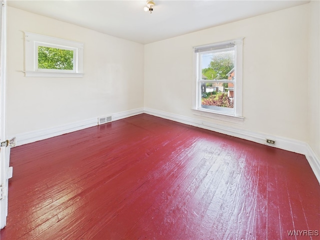 465 10th St, Niagara Falls, NY 14303 - empty room featuring healthy amount of natural light, baseboards, and wood finished floors