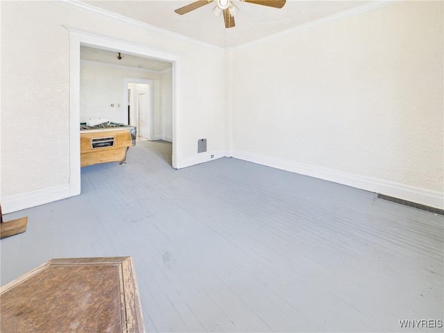 465 10th St, Niagara Falls, NY 14303 - empty room featuring a ceiling fan, wood finished floors, baseboards, and crown molding
