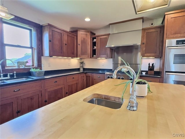 7294 Chase Rd, Pompey, NY 13063 - kitchen featuring a sink, stainless steel double oven, wall chimney range hood, open shelves, and recessed lighting