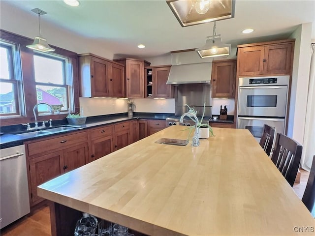 7294 Chase Rd, Pompey, NY 13063 - kitchen with a sink, stainless steel appliances, wall chimney range hood, pendant lighting, and open shelves