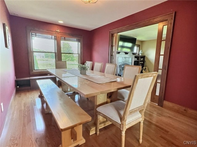 7294 Chase Rd, Pompey, NY 13063 - dining area featuring wood finished floors, baseboards, and a fireplace