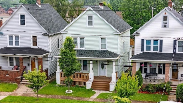 2238 Independence Ave, Niagara Falls, NY 14301 - traditional style home with covered porch, a chimney, and a front yard
