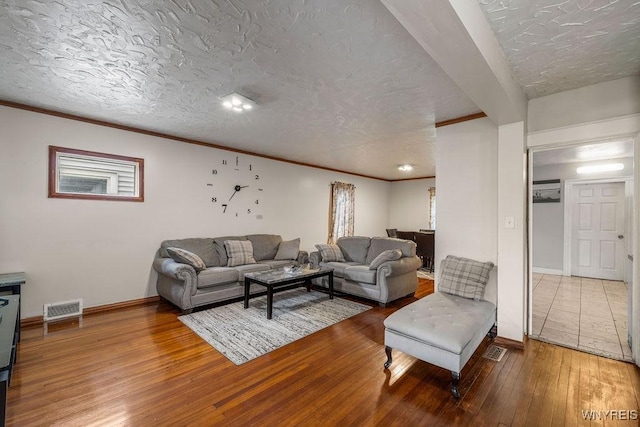 2238 Independence Ave, Niagara Falls, NY 14301 - living area featuring hardwood / wood-style flooring, a textured ceiling, ornamental molding, and baseboards