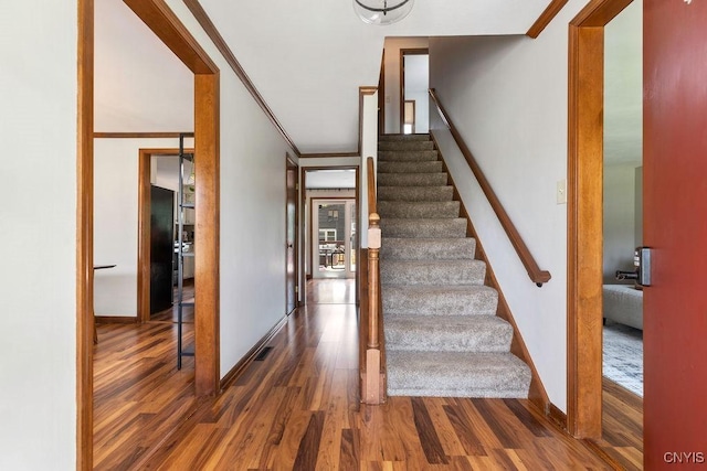 4292 Persimmon, Clay, NY 13090 - staircase with wood finished floors and baseboards