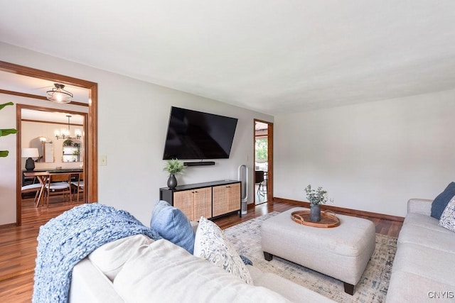 4292 Persimmon, Clay, NY 13090 - living area with a chandelier, wood finished floors, and baseboards