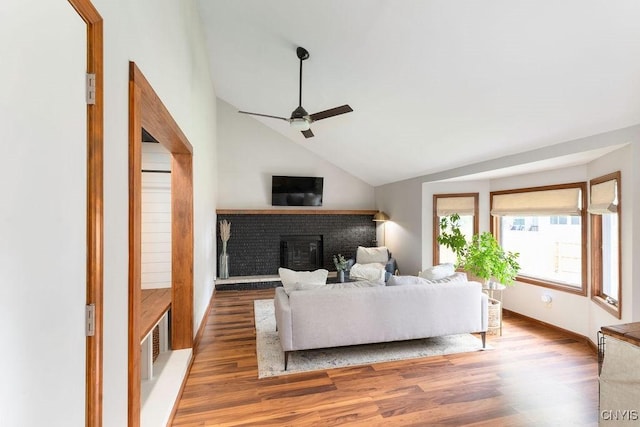 4292 Persimmon, Clay, NY 13090 - living room with ceiling fan, vaulted ceiling, wood finished floors, and a brick fireplace