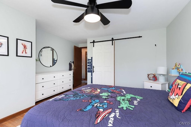 4292 Persimmon, Clay, NY 13090 - bedroom featuring a barn door, wood finished floors, ceiling fan, and baseboards