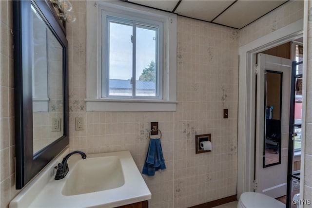 25 Waid St, Gouverneur, NY 13642 - bathroom featuring toilet, vanity, and tile walls