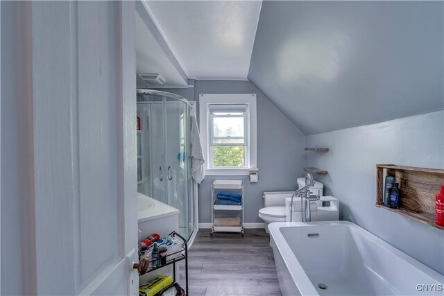 25 Waid St, Gouverneur, NY 13642 - full bathroom featuring toilet, a shower stall, vaulted ceiling, a garden tub, and wood finished floors