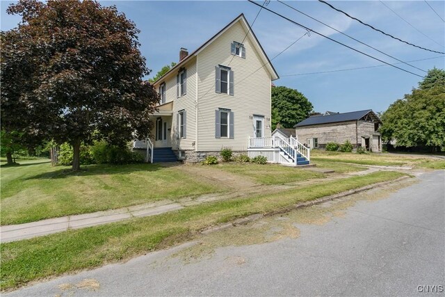 25 Waid St, Gouverneur, NY 13642 - view of front of home with a chimney and a front yard