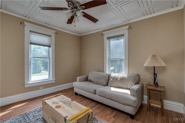 25 Waid St, Gouverneur, NY 13642 - living area with baseboards, ceiling fan, wood finished floors, and an ornate ceiling