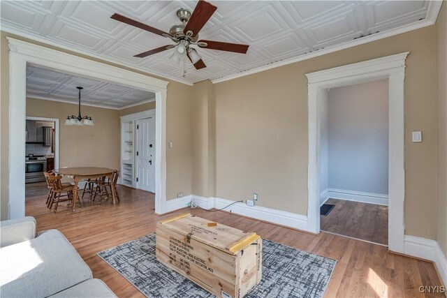 25 Waid St, Gouverneur, NY 13642 - living area with a ceiling fan, baseboards, wood finished floors, and a chandelier